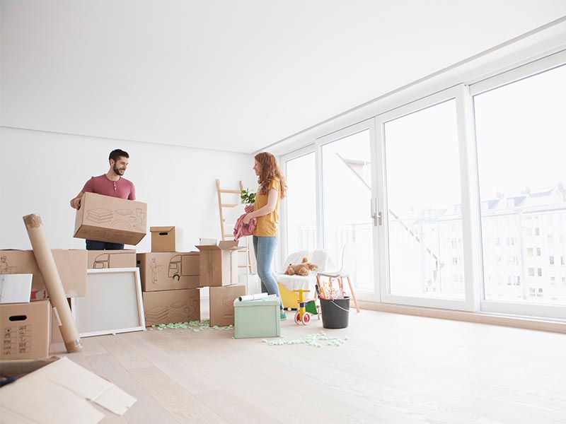 couple unpacking moving boxes in first home